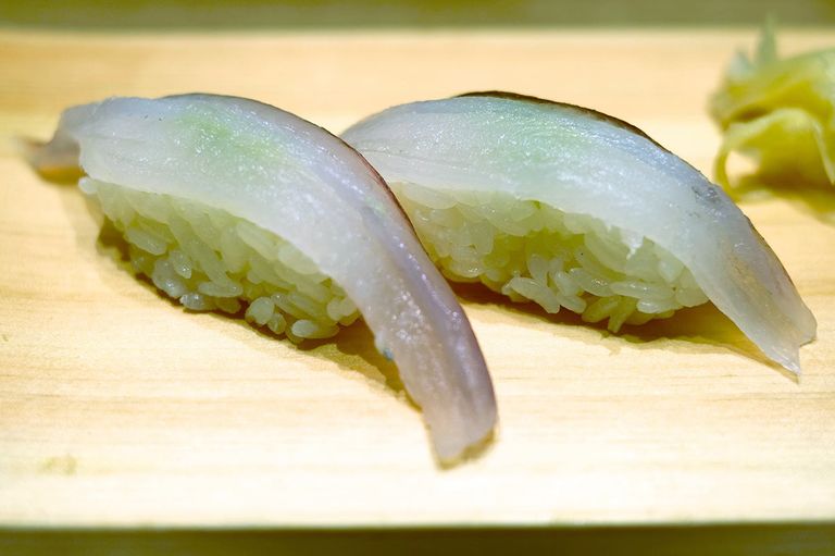 Close-up of Aka Yagara Nigiri, delicately draped over pressed sushi rice