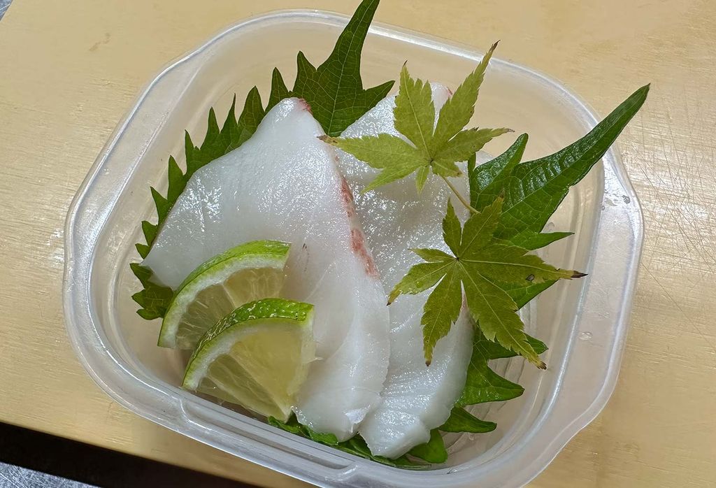 Slices of escolar sashimi with opaque white flesh and a smooth oily sheen, visually reminiscent of bintoro