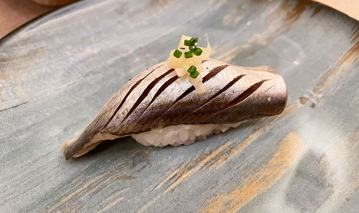 Hand formed sushi (nigiri-zushi) for which a European sardine (Japanese nishi-iwashi) served as an ingredient.