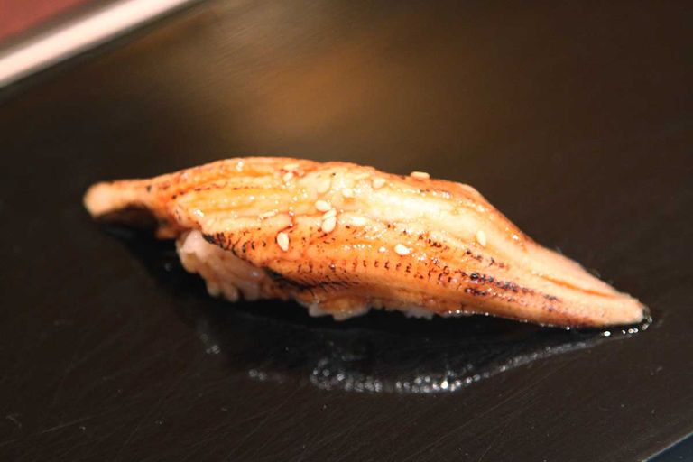 Eel (unagi) sushi on a plate.