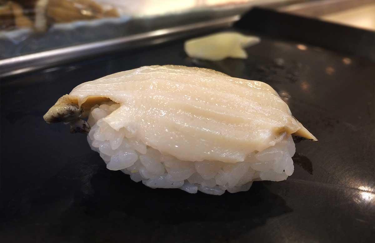 Awabi Nigiri Sushi that is on a plate. 
				Dennis Schilder. 
				Iki Awabi Sushi (活あわび). 
				
				Copyright ©. 
				